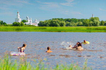 Children swim in the river on a sunny summer dayの写真素材