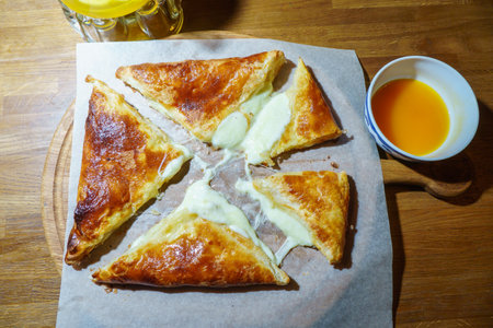 Slices of pie with cottage cheese and sour cream on a wooden table