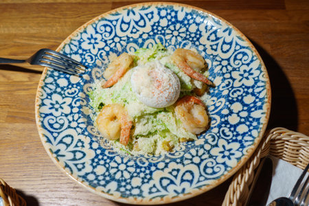 Shrimp salad with egg and parmesan cheese on a plateの写真素材