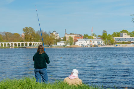 Two women fishing on the bank of the Volga River, Russiaの写真素材