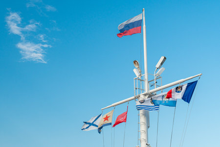 Flags of the Russian Federation on the mast of a ship against the blue sky