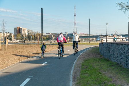 Cyclists on the embankment of the river in spring