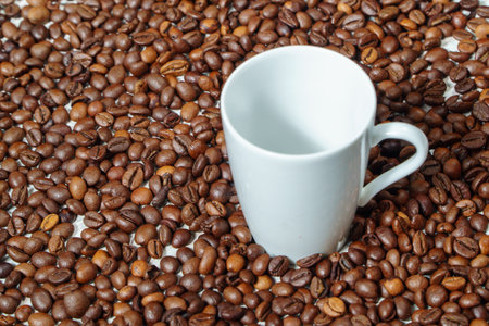 Coffee cup and coffee beans on white background, closeupの写真素材