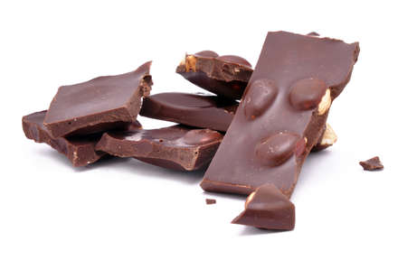 Broken chocolate with nuts on a white background