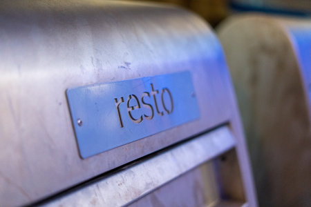 Close up detail of stainless steel trash bin with modern metallic surface indoors.