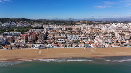 Aerial drone view of Guardamar del Segura coastline with sandy beach, Mediterranean Sea and seaside...