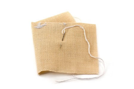 Fabrics, flax, needle with thread, embroidery, beige