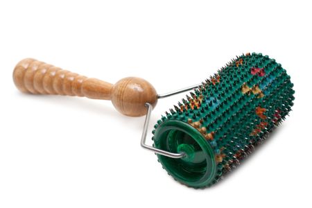 Cylindrical massager with needle and wooden handle on white backgroundの写真素材