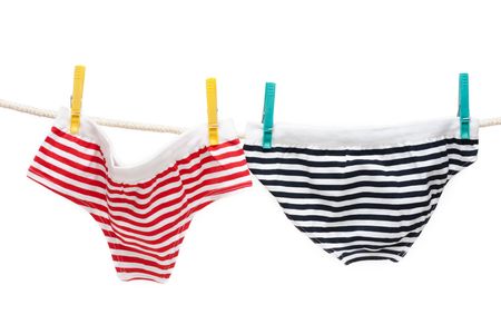 Colour undershorts hung on linen rope with clothes-pegの写真素材