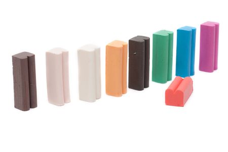 Varicoloured columns plasticine insulated on white background