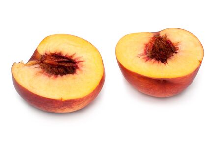 Ripe peach cut on two parts on white backgroundの写真素材