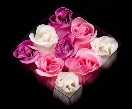 Fabrics rose in transparent box on black backgroundの写真素材