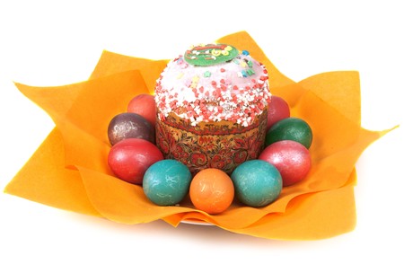 Easter pie in glaze and dyed egg on orange napkin insulated on white background