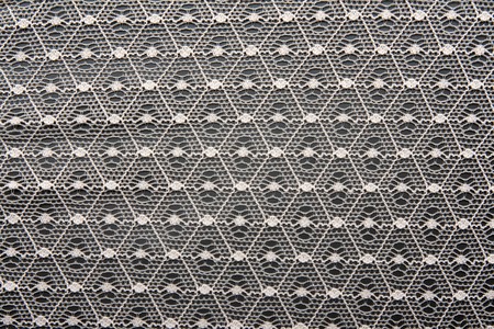 White lace in the manner of nets on black backgroundの写真素材