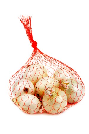 Light onion in packing from red net on white backgroundの写真素材