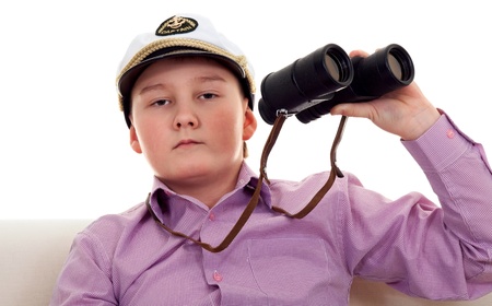 Strict boy with glasses and a cap Captainの写真素材