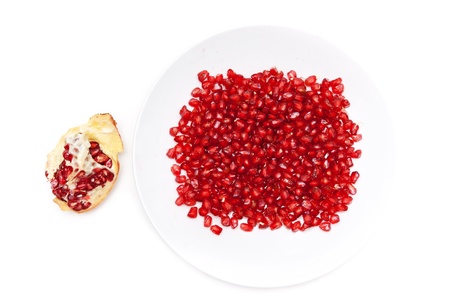 Red pomegranate seeds on a plate, and peeled fruit
の写真素材