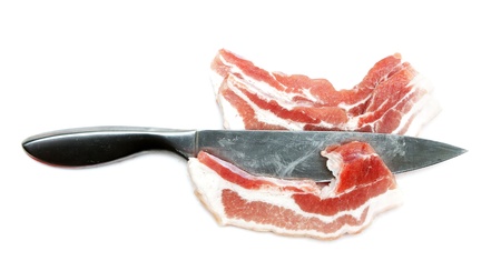 Chunks of raw meat with a steel knife on a white background