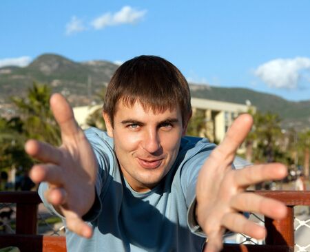 Portrait men on nature, pulls hands to spectatorの写真素材