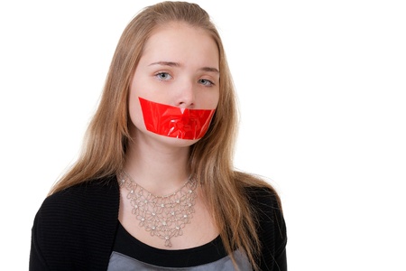 beautiful girl with her mouth sealed with red tapeの写真素材