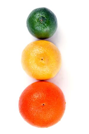 orange lemon and lime arranged in a row on a white backgroundの写真素材