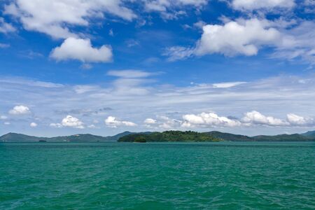 Landscape of palm island on the horizon in the Andaman Sea with blue sky and cloudsの写真素材