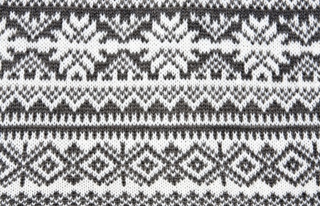 gray background with a knitted pattern to form snowflakesの写真素材