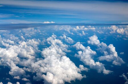 clouds against the blue sky, view from airplane