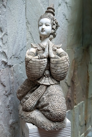 Asian statue in the form of a girl prayingの写真素材