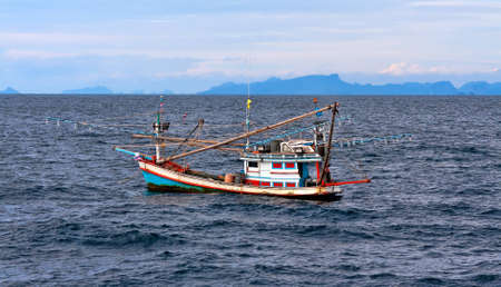 Thai fishing schooner at sea in bad weather conditions