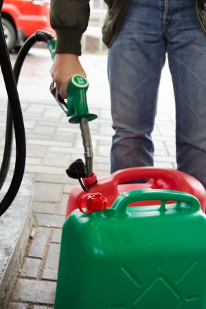 Man in jeans gas station in a plastic gasoline canister 98Eの写真素材