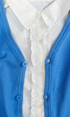 Trendy blue cardigan with a white shirt closeupの写真素材