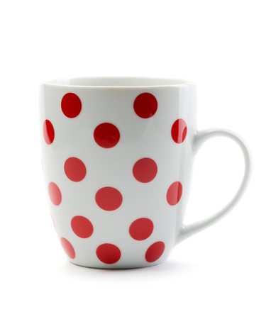 Porcelain cup with red polka dots. Isolate on white.の写真素材
