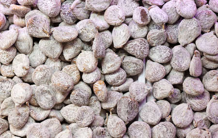 Dried figs in flour as backgroundの写真素材