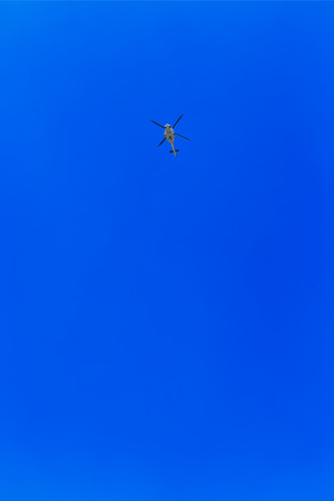 Helicopter in the air across clear skyの写真素材