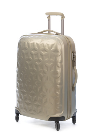 Beige plastic suitcase on wheels for travel. Isolate on white.の写真素材