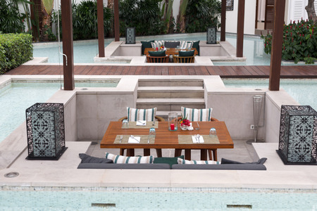 Tables with dishes by the poolの写真素材