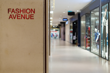 Sign of Fahsion Avenue in the shopping center in the background of shop windowsの写真素材