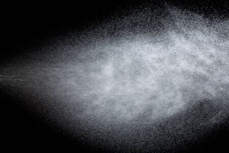 Spraying of water from the sprinkler. Isolate on black background.