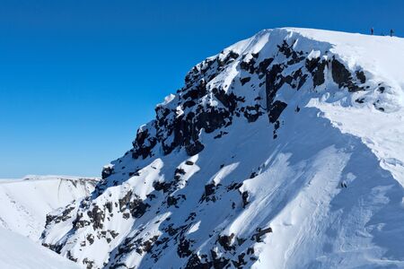 Snowy mountain in the background of the blue sky