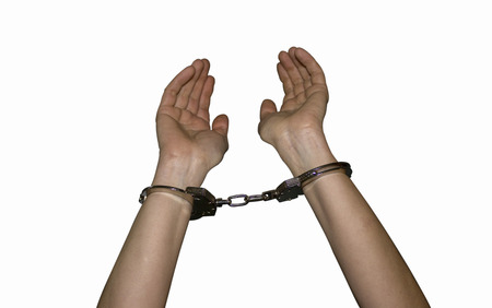 police handcuffs on the hands of women a crime and a crime white backgroundの写真素材