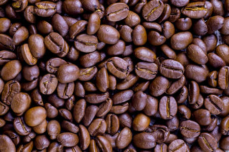 grains of black fragrant coffee scattered on the table