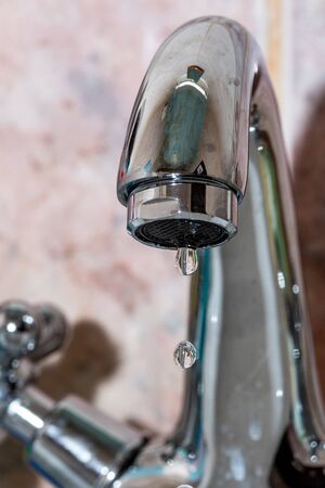 water dripping from the water supply and the lack of waterの写真素材