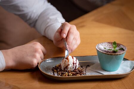 chocolate fondue with a piece of mint on the table, delicious to eat with a spoonの写真素材