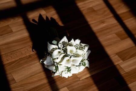 bouquet of white lilies in the sun with hard shadowsの写真素材