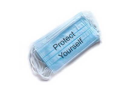 Medical mask PROTECT YOURSELF. Coronavirus COVID-19 pandemic. Medical protective masks isolated on white background. Protective face mask or medical mask. Healthcare and medical concept.の写真素材