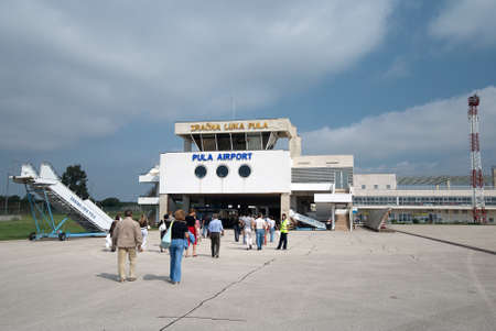 Pula, Croatia - August 29, 2007: Airport of Pula town (Istria region, Adriatic seashore), passengers moving to the terminal.のeditorial素材