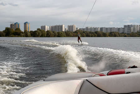 Moscow, Russia - September 28, 2008: Wakeboarding rider showing tricks and skills at free ride on the city river. Wakeboarder behind the motorboatのeditorial素材