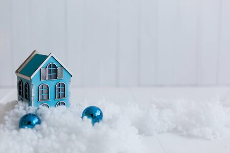 Beautiful toy wooden houses on a snowy background, Christmas toysの写真素材