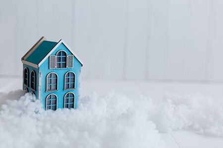 Beautiful toy wooden houses on a snowy background, Christmas toysの写真素材